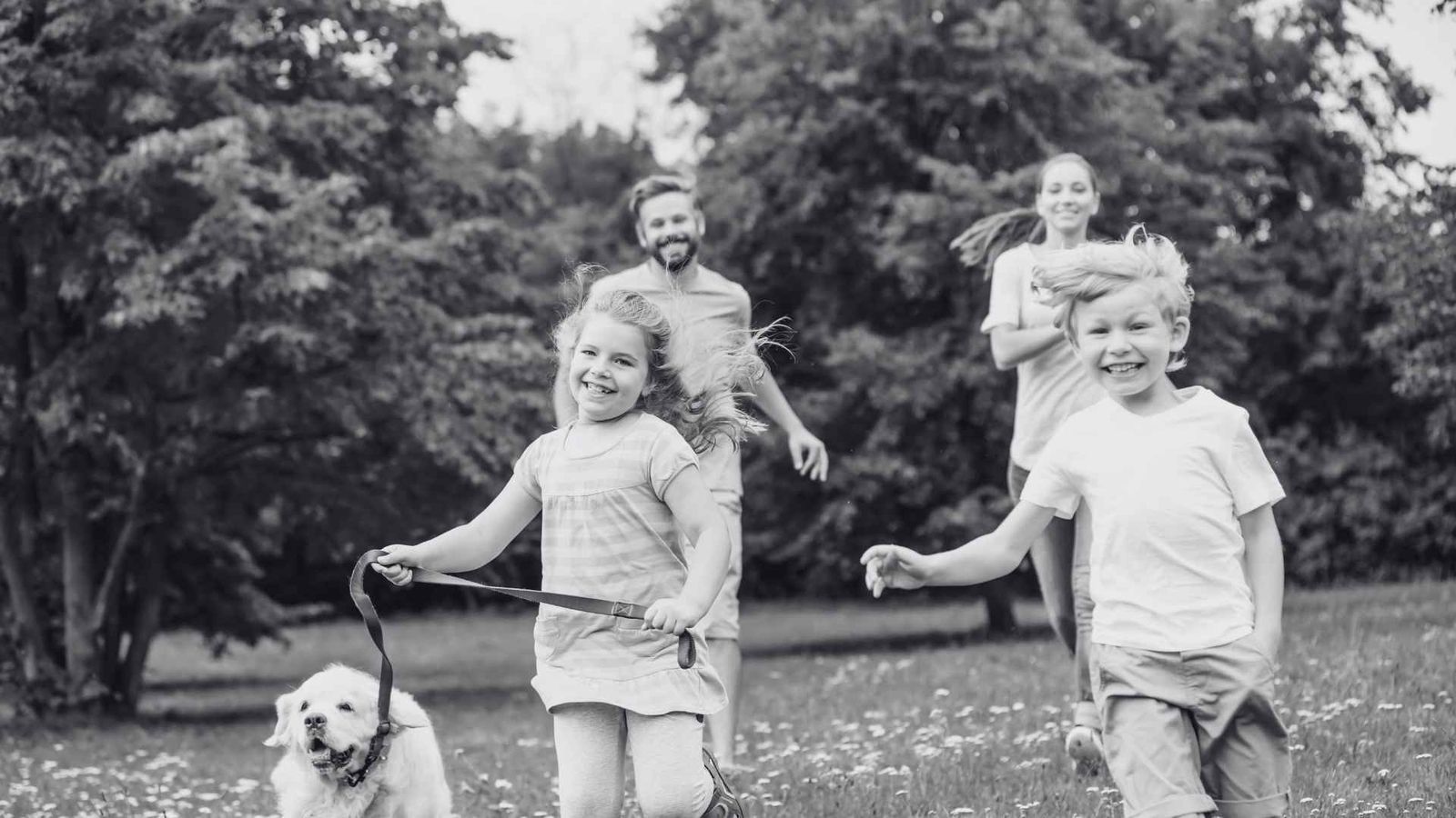 Family running together outdoors with their dog - podiatry care for all ages at Fairfield Sports Podiatry